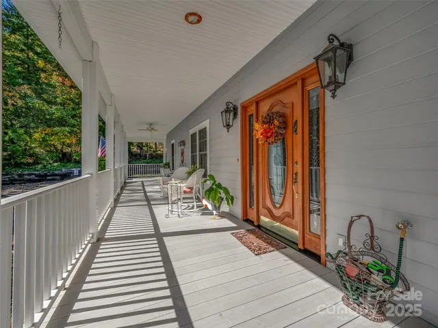 a balcony with furniture and a potted plant