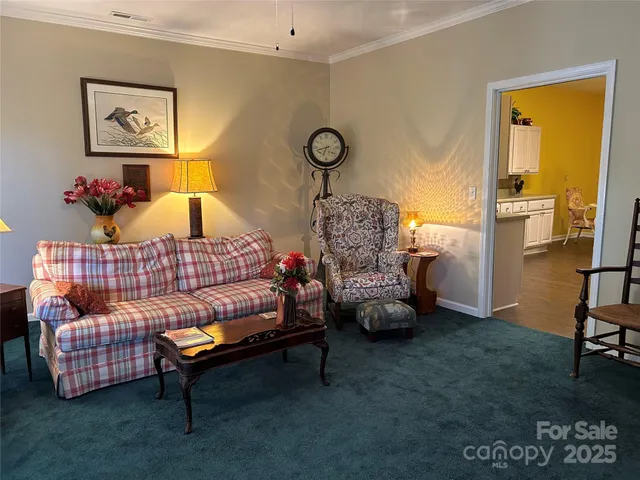 a bed sitting in a bedroom next to a lamp