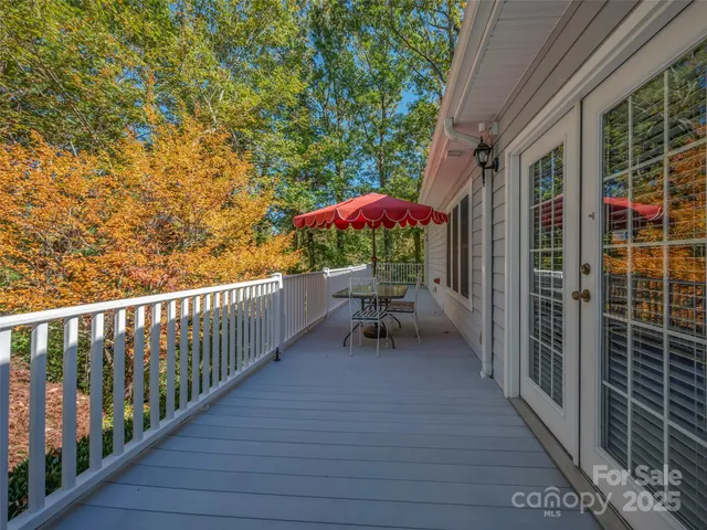 a view of a hallway with wooden floor and windows