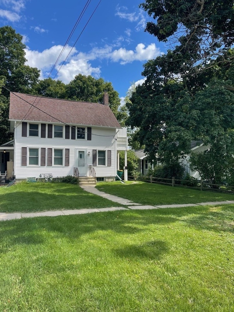 326 1/2 South Walnut Street Sycamore, IL 60178 - Photo 3 of 10 a front view of a house with a garden