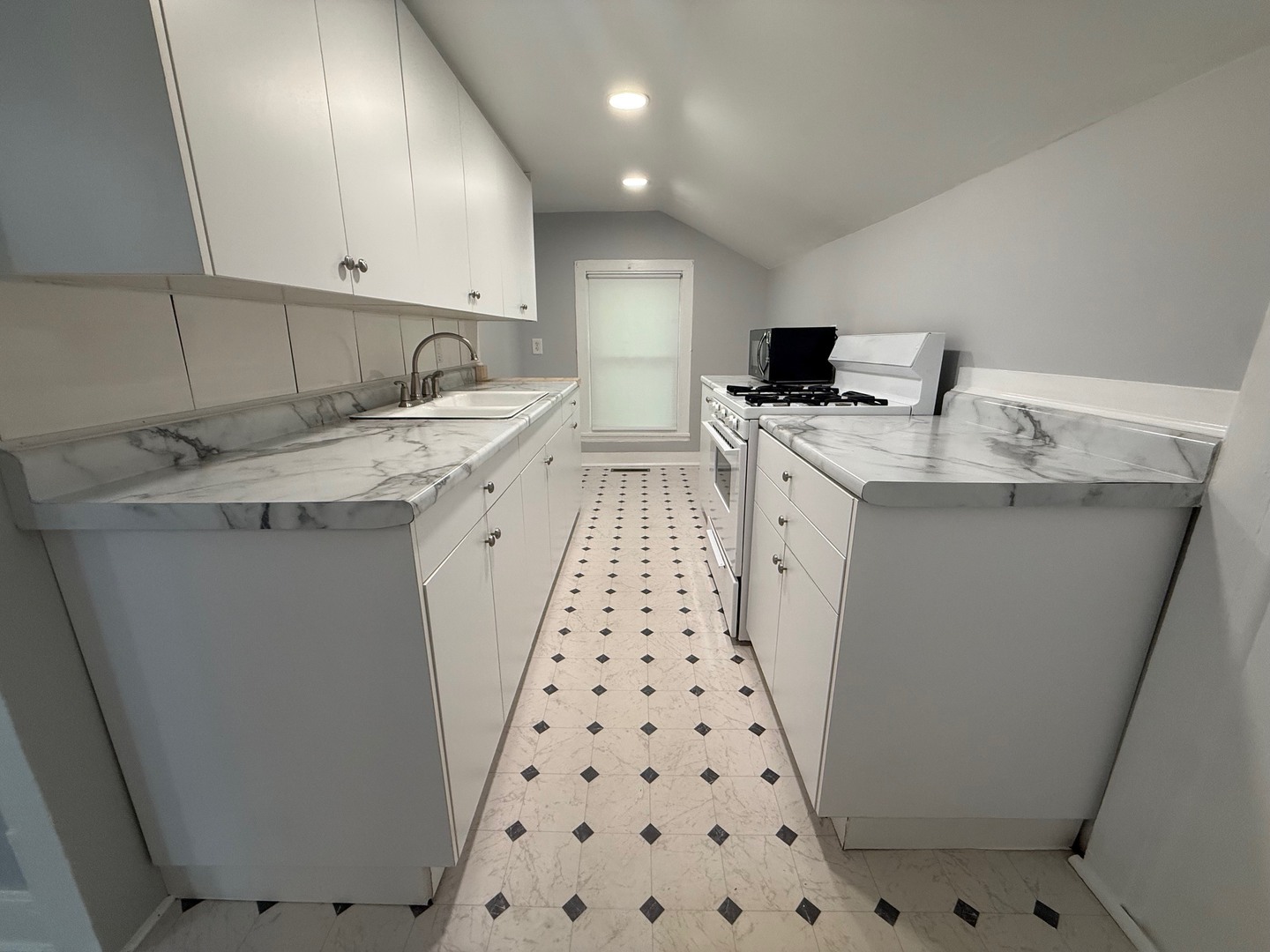326 1/2 South Walnut Street Sycamore, IL 60178 - Photo 8 of 10 a kitchen with sink a microwave a stove and refrigerator