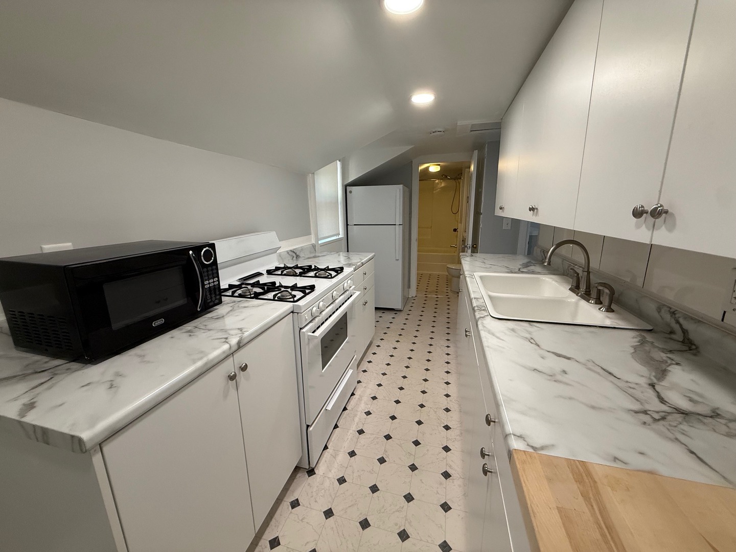 326 1/2 South Walnut Street Sycamore, IL 60178 - Photo 9 of 10 a kitchen with a sink a stove and cabinets