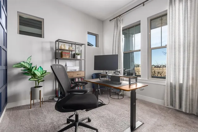 a view of a workspace with furniture and a potted plant