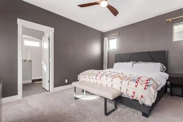 a large bed sitting in a bedroom and a chandelier