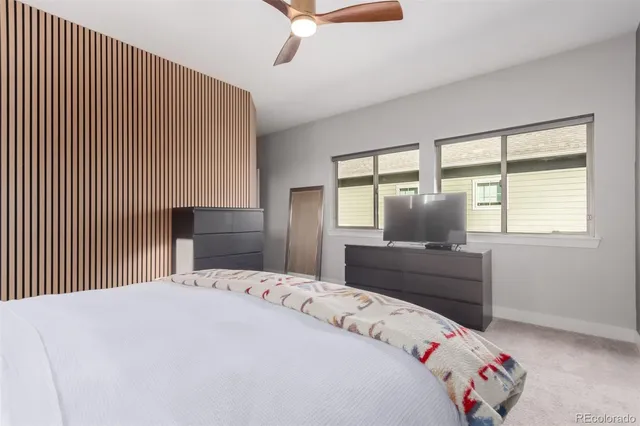 a bedroom with a bed and a large window