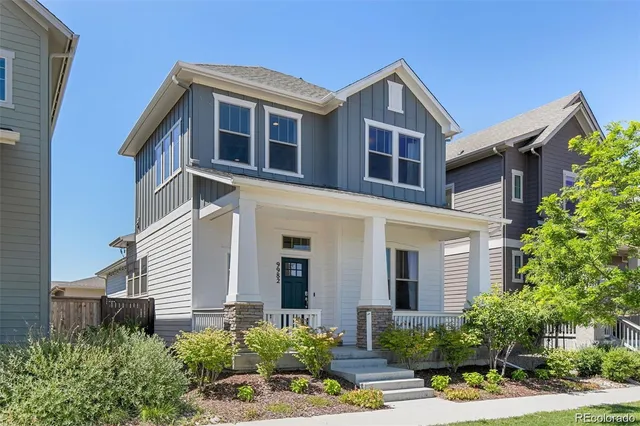 a front view of a house with yard and green space