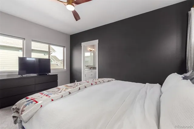 a bedroom with a bed and a flat tv screen