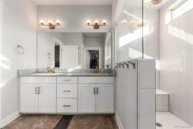 a bathroom with a double vanity sink and a mirror