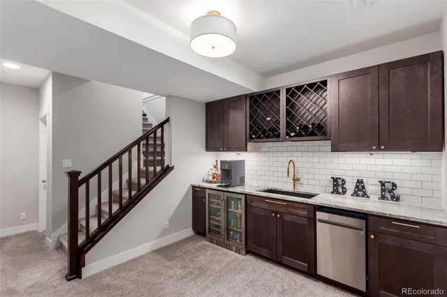a kitchen with stainless steel appliances granite countertop a sink and cabinets