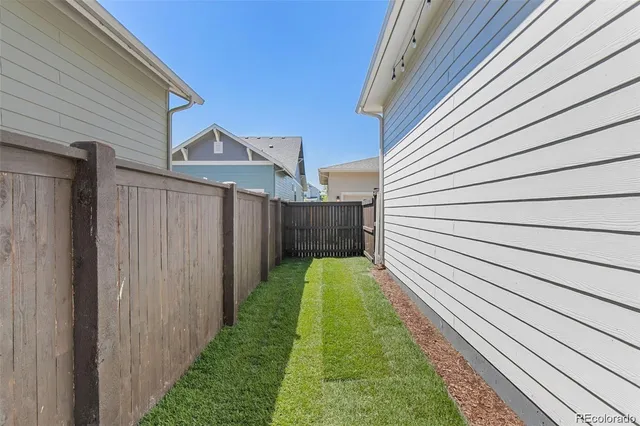 a view of a backyard with wooden fence