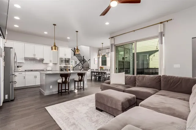 a living room kitchen with furniture and a large window