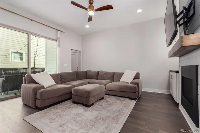 a living room with furniture a large window and a rug