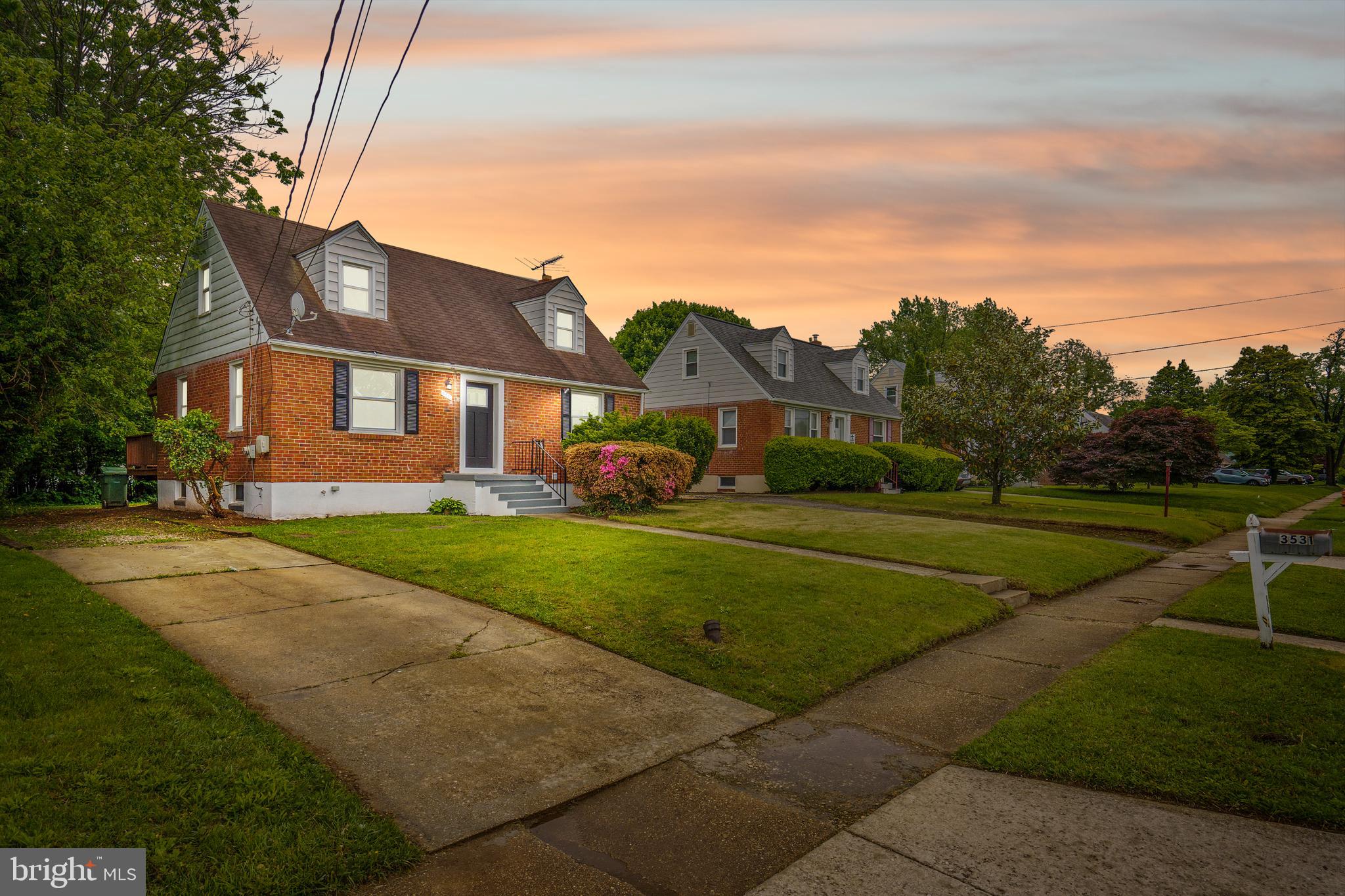 3531 Milford Mill Road Baltimore, MD 21244 - Photo 1 of 49 a front view of a house with a yard and trees