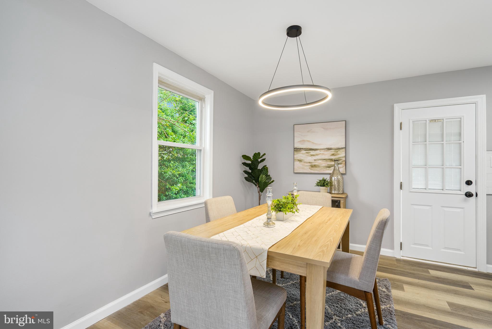3531 Milford Mill Road Baltimore, MD 21244 - Photo 11 of 49 a view of a dining room with a table chairs and chandelier