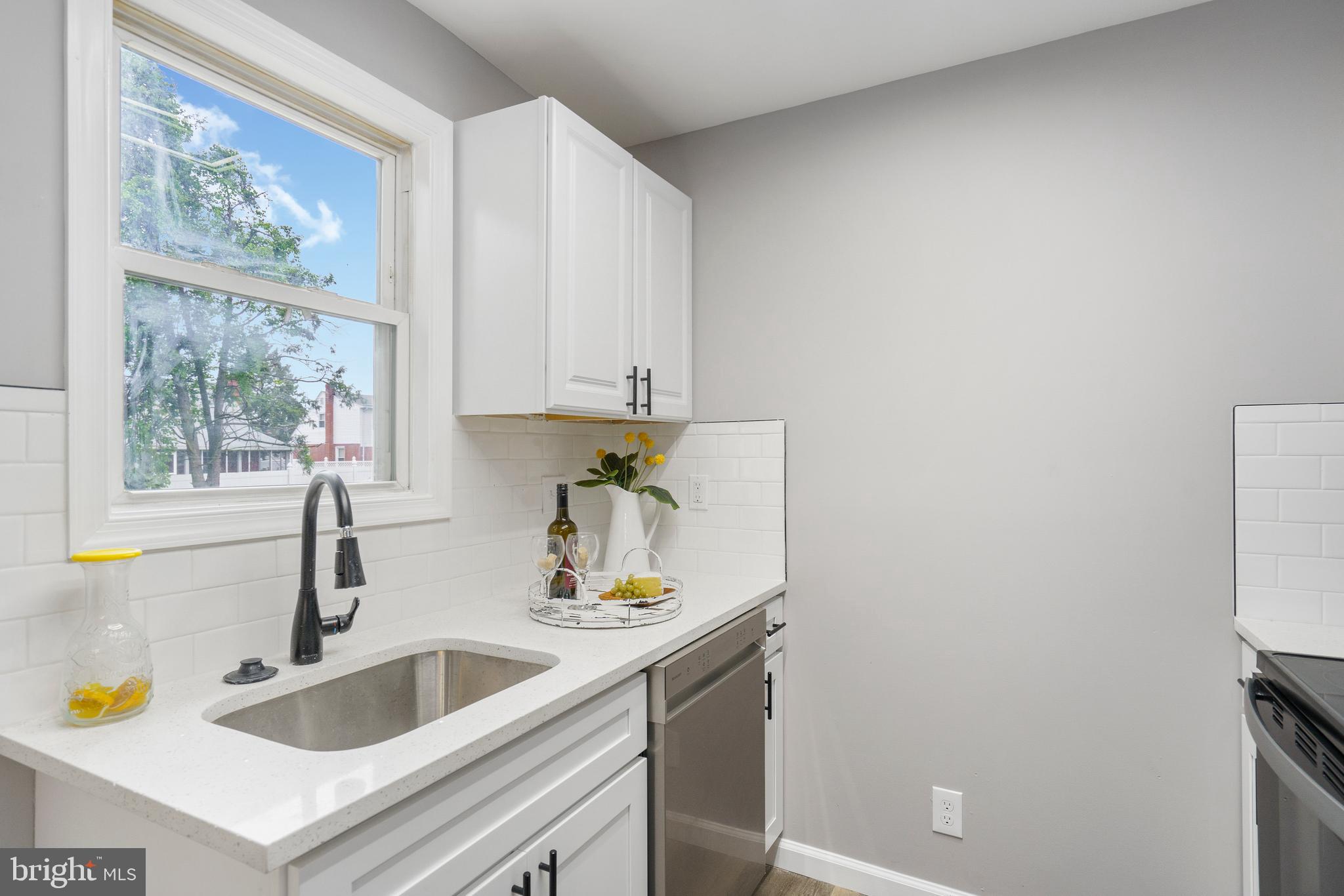 3531 Milford Mill Road Baltimore, MD 21244 - Photo 16 of 49 a kitchen with a sink cabinets and a window