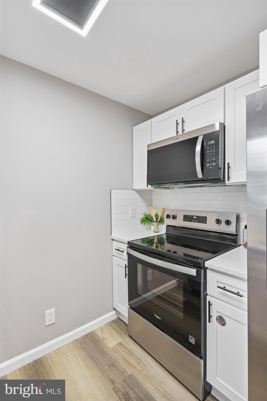 3531 Milford Mill Road Baltimore, MD 21244 - Photo 19 of 49 a kitchen with a stove and a microwave