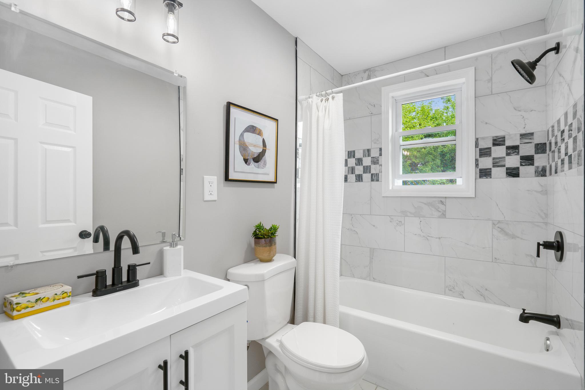 3531 Milford Mill Road Baltimore, MD 21244 - Photo 27 of 49 a bathroom with a sink mirror toilet and bathtub