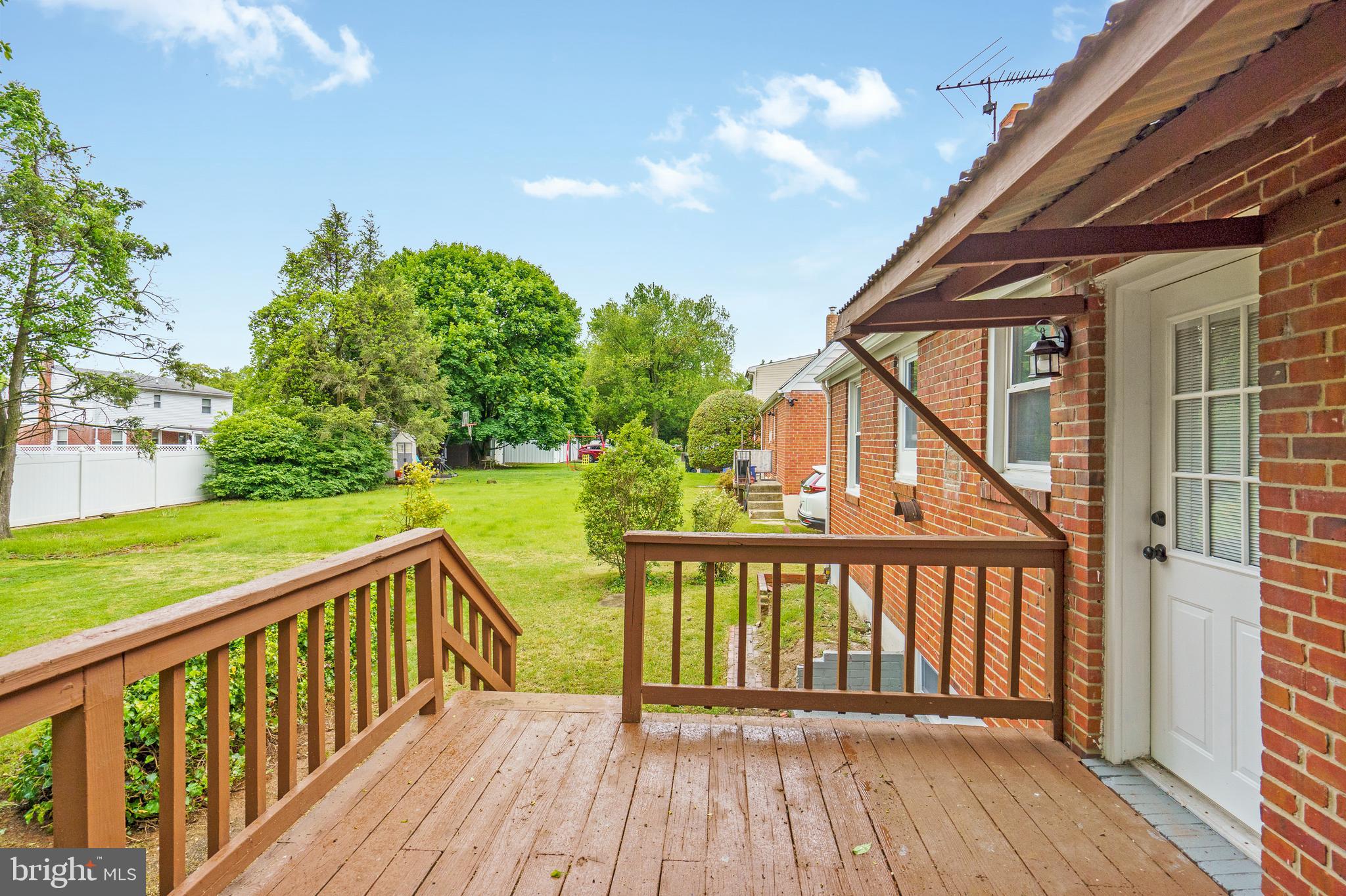 3531 Milford Mill Road Baltimore, MD 21244 - Photo 43 of 49 a view of a deck with wooden floor and fence with a large garden