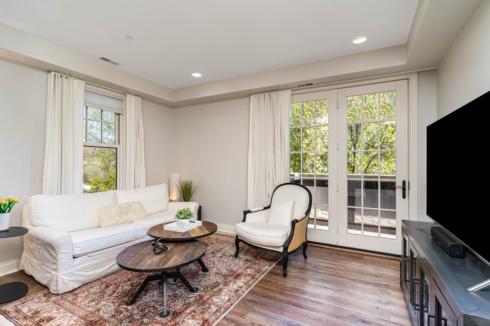 720 Green Bay Road, Unit 2E Winnetka, IL 60093 - Photo 2 of 13 a living room with furniture a flat screen tv and a large window