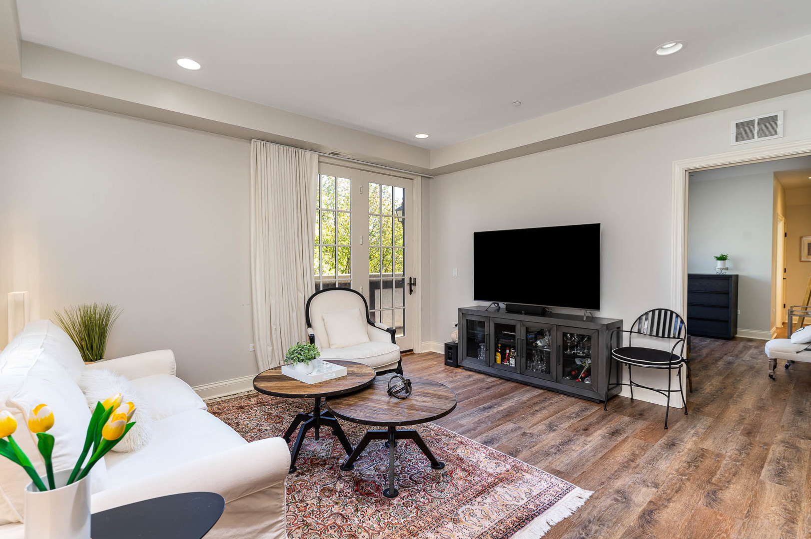 720 Green Bay Road, Unit 2E Winnetka, IL 60093 - Photo 5 of 13 a living room with furniture and a flat screen tv