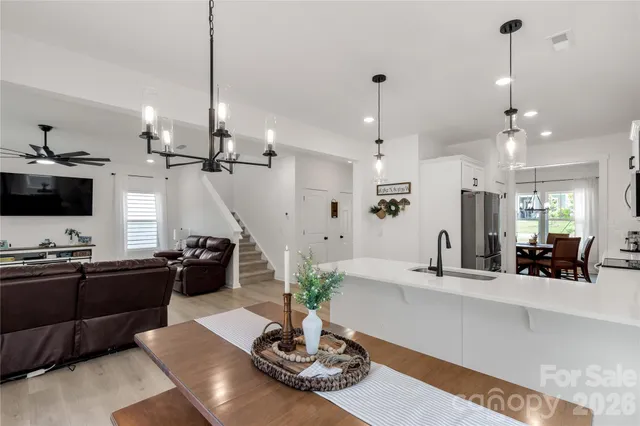 a living room with kitchen island furniture and a flat screen tv