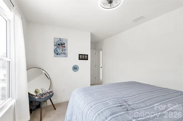 a bedroom with a bed and a chair