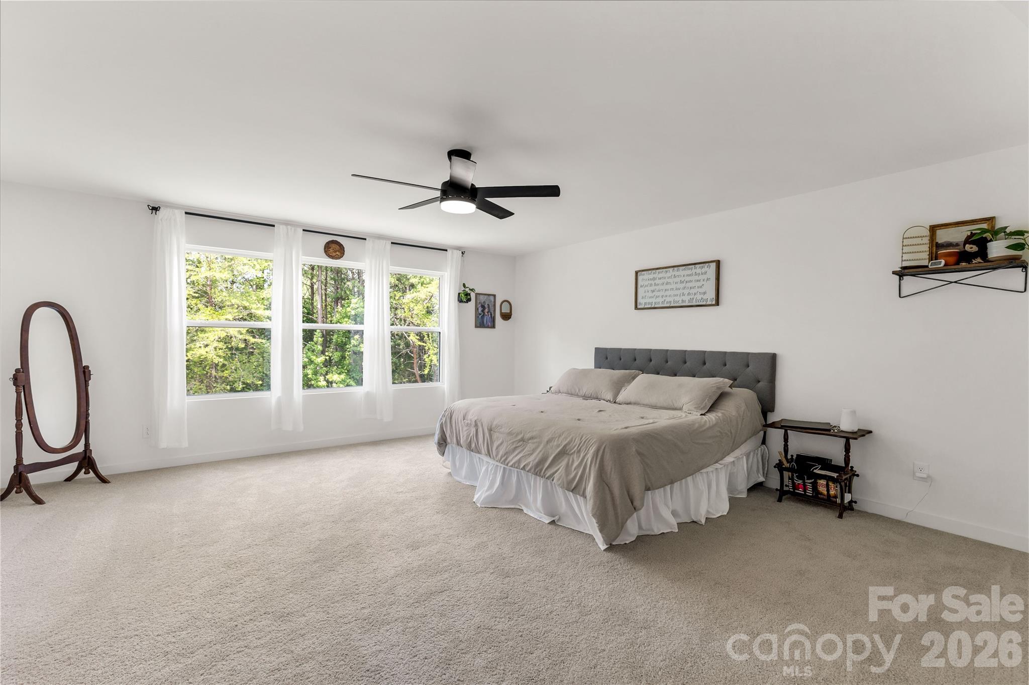 11117 Argosy Drive Lancaster, SC 29720 - Photo 25 of 37 a spacious bedroom with a bed a chandelier and a window