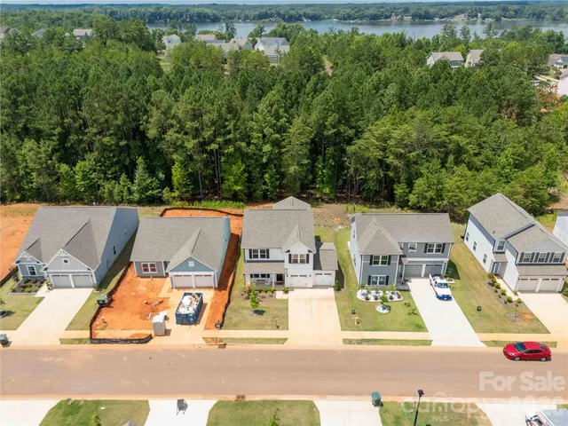 an aerial view of residential house with outdoor space and trees around
