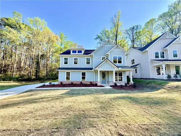 a front view of a house with a yard table and chairs