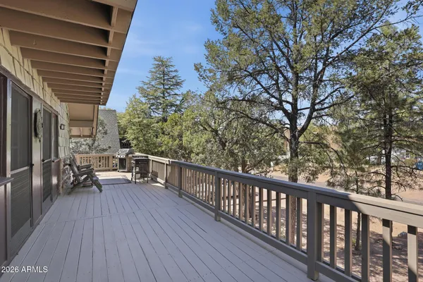 a view of balcony with wooden floor and outdoor seating