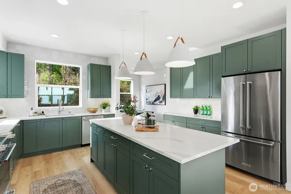 a kitchen with a sink dishwasher a refrigerator and a sink