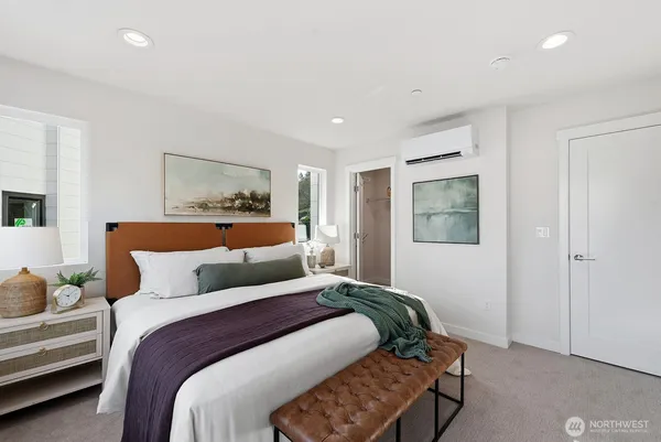 a bedroom with a large bed and a couch