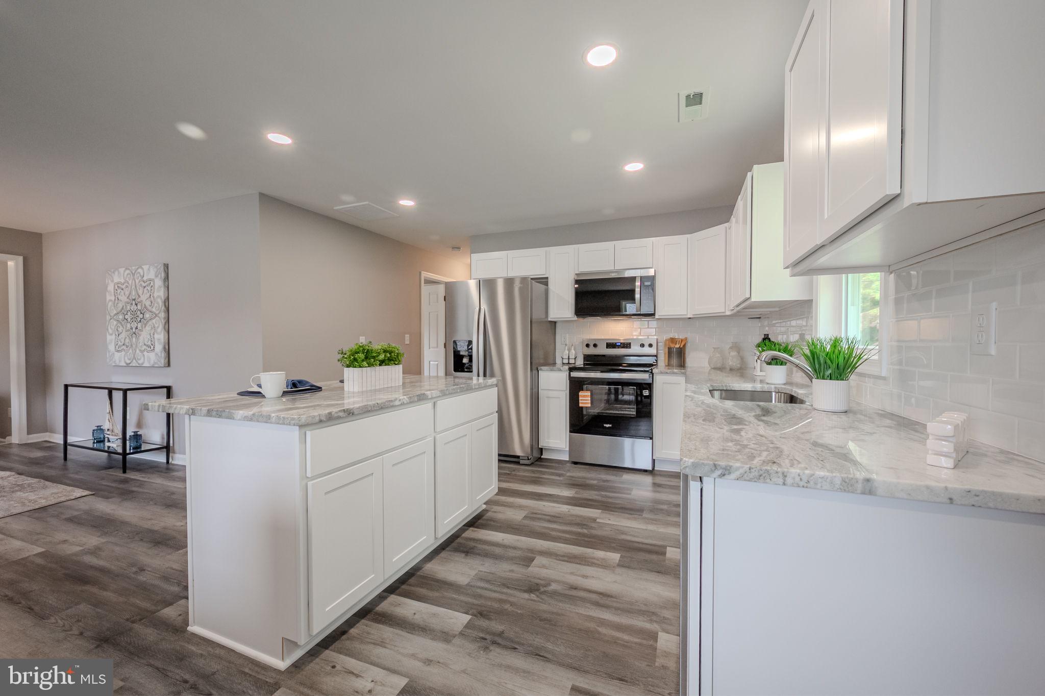 23110 Old Fairlee Road Chestertown, MD 21620 - Photo 12 of 29 a large kitchen with kitchen island a large counter top stainless steel appliances and cabinets