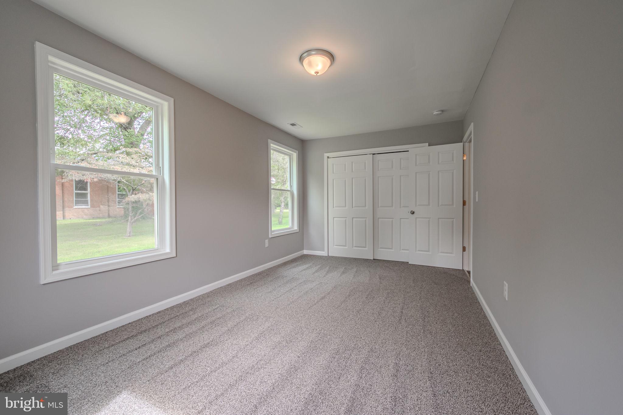 23110 Old Fairlee Road Chestertown, MD 21620 - Photo 21 of 29 an empty room with windows and closet
