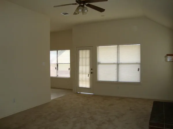 an empty room with a empty space and windows
