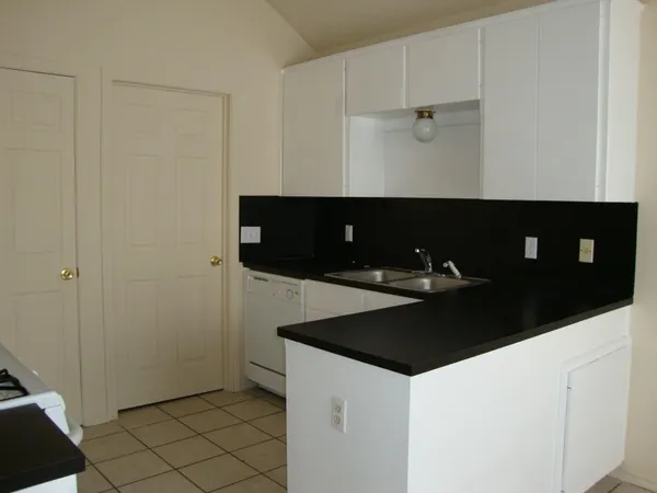 a kitchen with a sink and cabinets