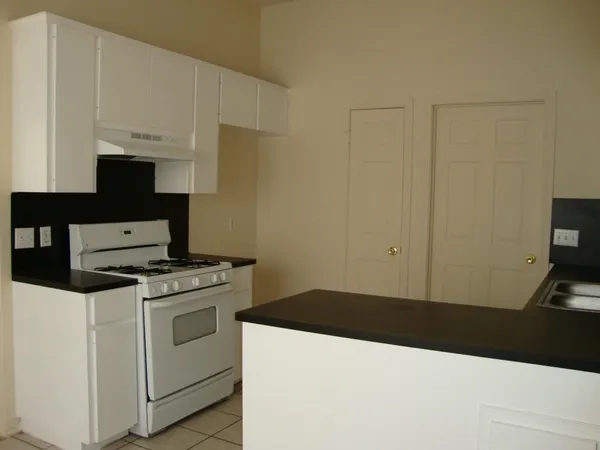 a kitchen with a stove and a sink