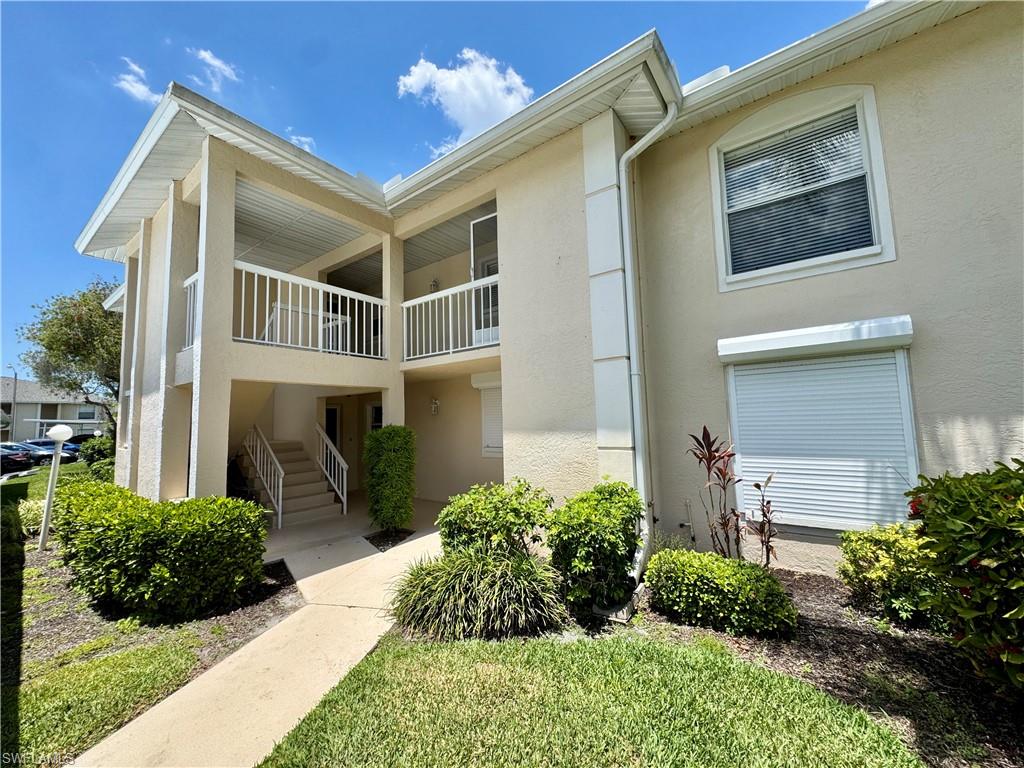 661 Squire Circle, Unit 101 Naples, FL 34104 - Photo 5 of 25 a front view of a house with a yard