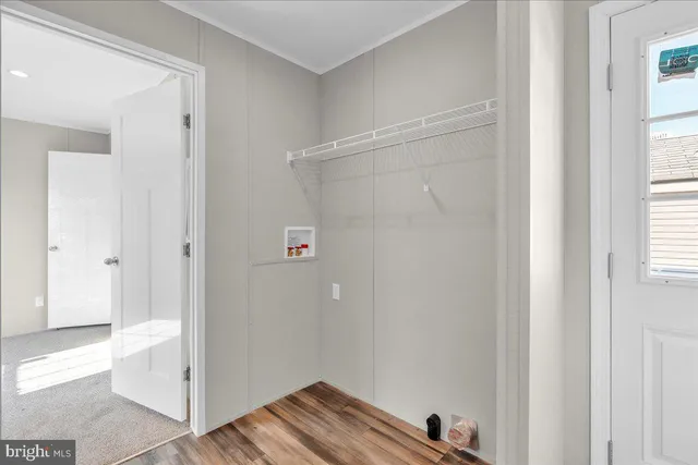 a view of room with hardwood floor and window