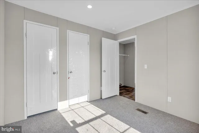 a view of an empty room and hallway