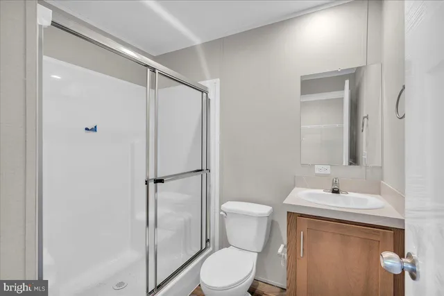 a bathroom with a toilet sink and shower