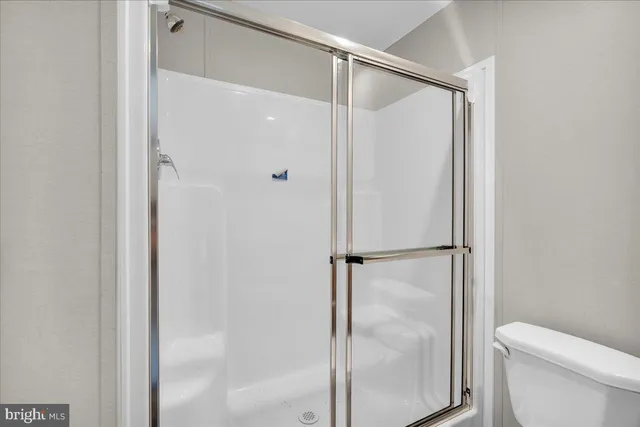 a bathroom with a glass shower door