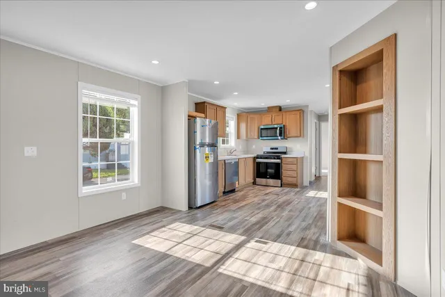 a kitchen with stainless steel appliances granite countertop a refrigerator and a sink