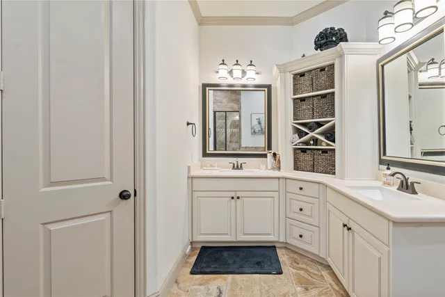 a spacious bathroom with a double vanity sink a mirror and window
