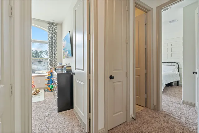 a view of a hallway with windows and closet