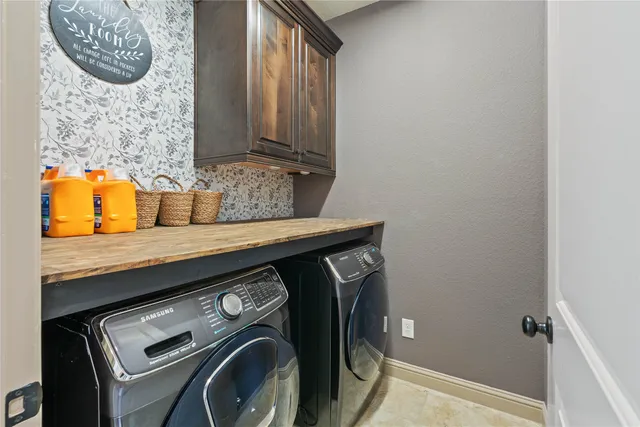 a utility room with a sink a washer and dryer