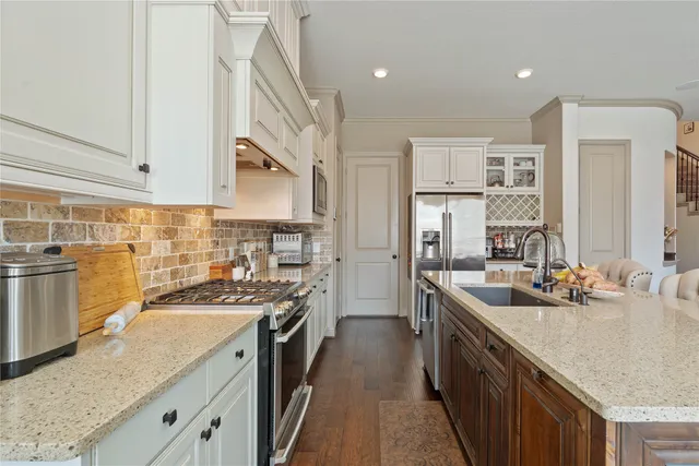 a kitchen with a sink stove and cabinets
