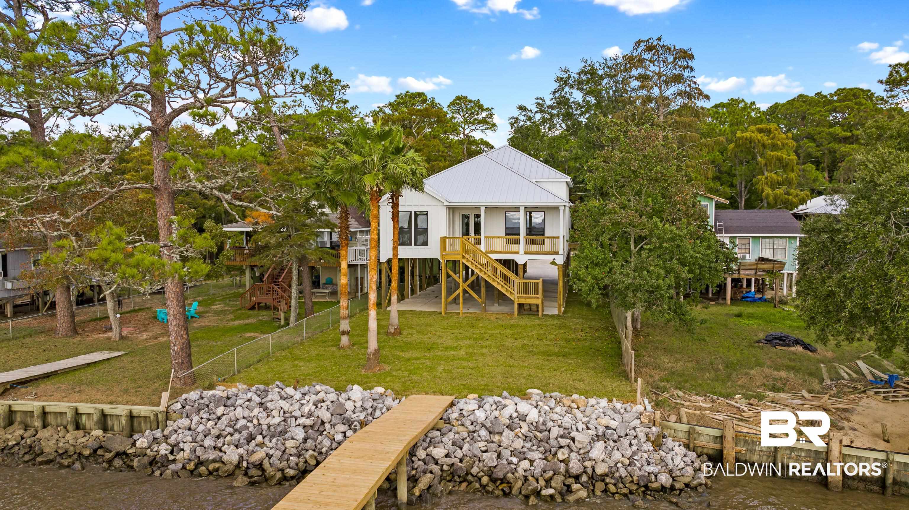 12453 County Road 1 Fairhope, AL 36532 - Photo 29 of 33 Rear view of house with a lawn and a wooden deck