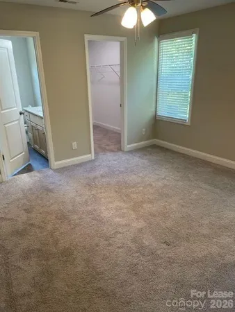 an empty room with windows and closet