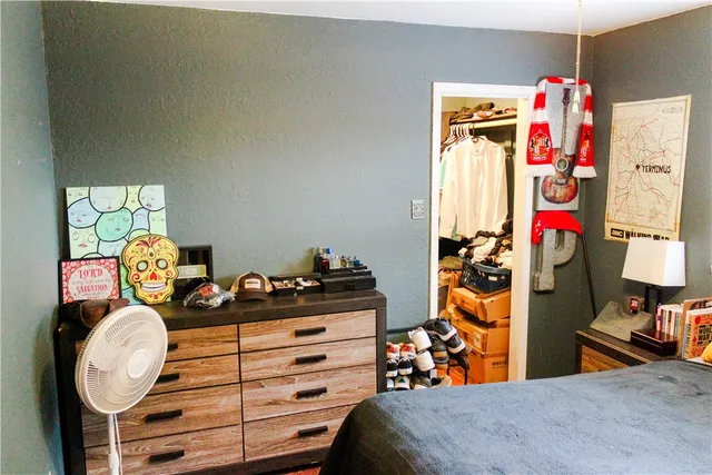 a bed room with a bed and a window